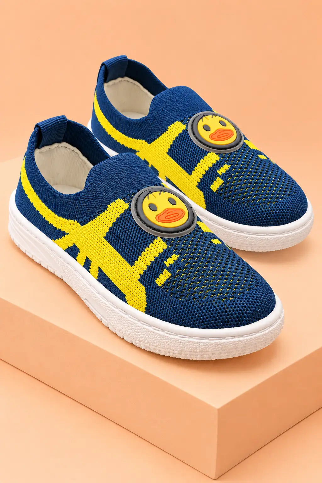 Bebe Unicorn kids knit slip-on sneakers in navy blue with yellow pattern and duck face patch, pair view