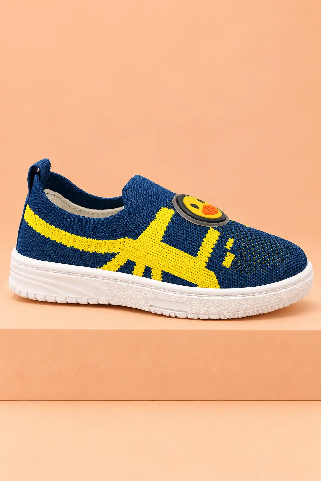 Side view of navy blue boys slip-on shoe with yellow knit stripe, white sole and heel pull tab