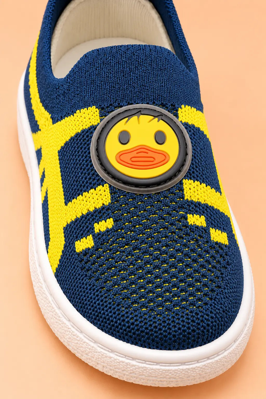 Close-up of breathable navy and yellow knitted mesh upper with rubberised duck patch