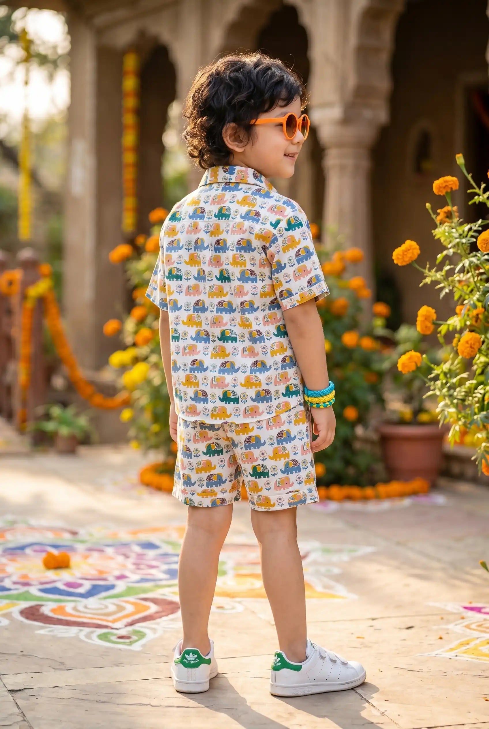 Detailed view of colorful elephant & flower print on boys casual shirt, nature-inspired design on white cotton, playful kid-friendly