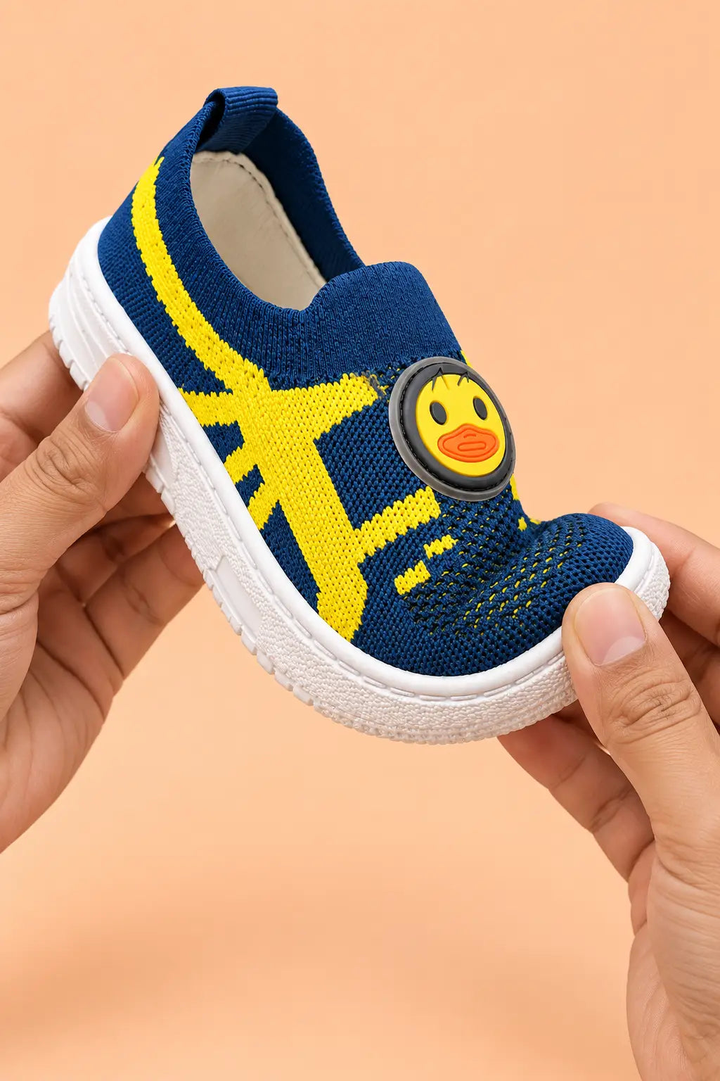 Hands bending navy blue kids sneaker to show soft flexible sole for natural foot movement