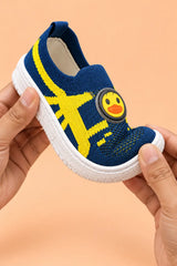 Hands bending navy blue kids sneaker to show soft flexible sole for natural foot movement