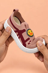 Hands bending toddler sneaker to show soft flexible sole for natural foot movement