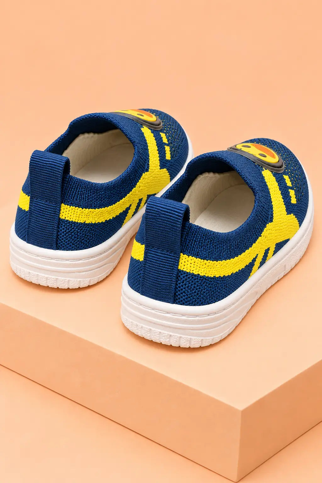 Back view of navy blue toddler slip-on sneakers with heel pull tabs for easy on and off