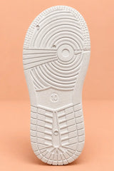 Anti-skid white sole of kids sneakers with circular grip tread pattern