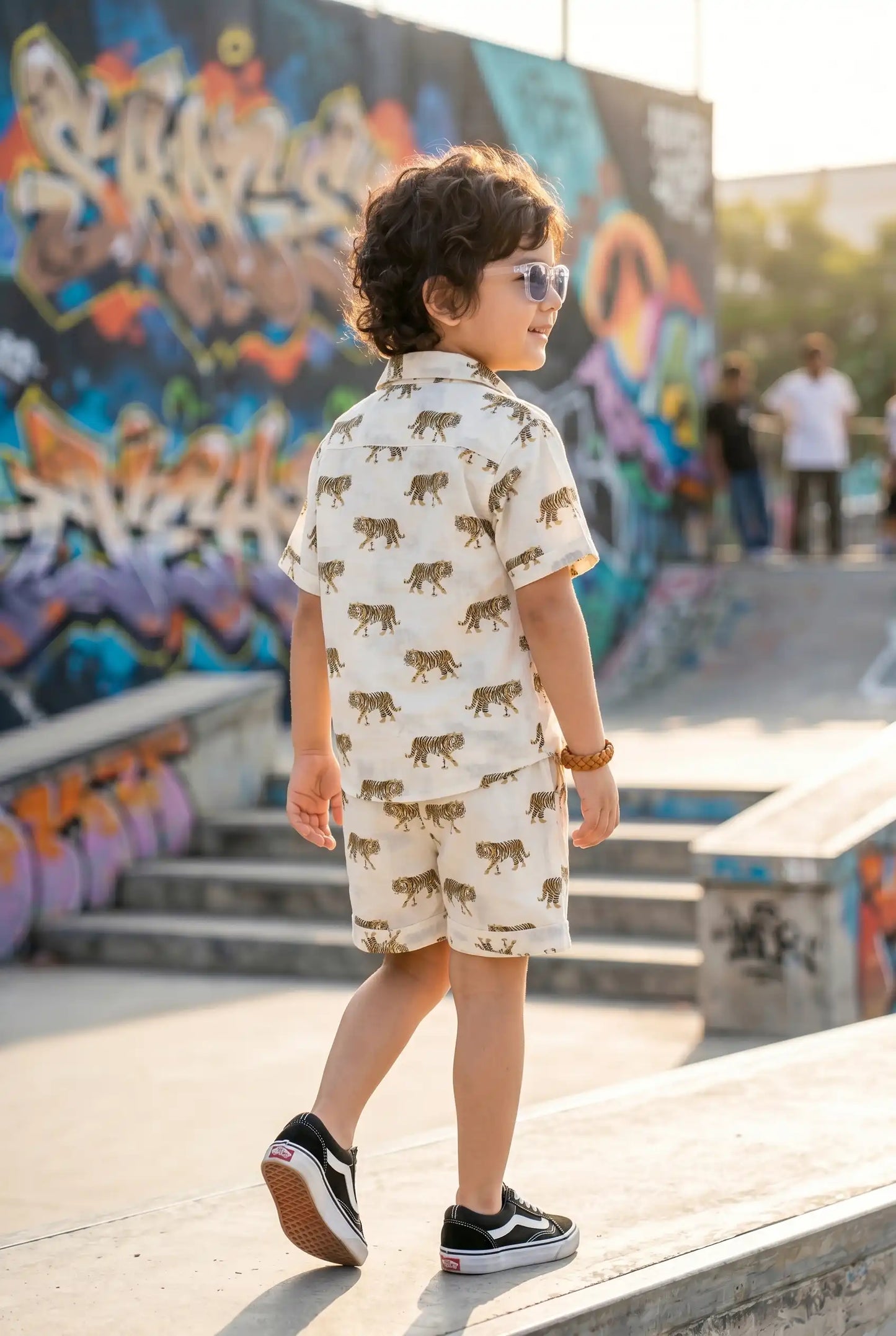 Detailed view of brown striped tiger print on boys casual shirt, white cotton, bold kid-friendly wild design