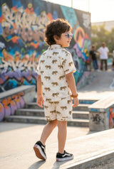 Detailed view of brown striped tiger print on boys casual shirt, white cotton, bold kid-friendly wild design