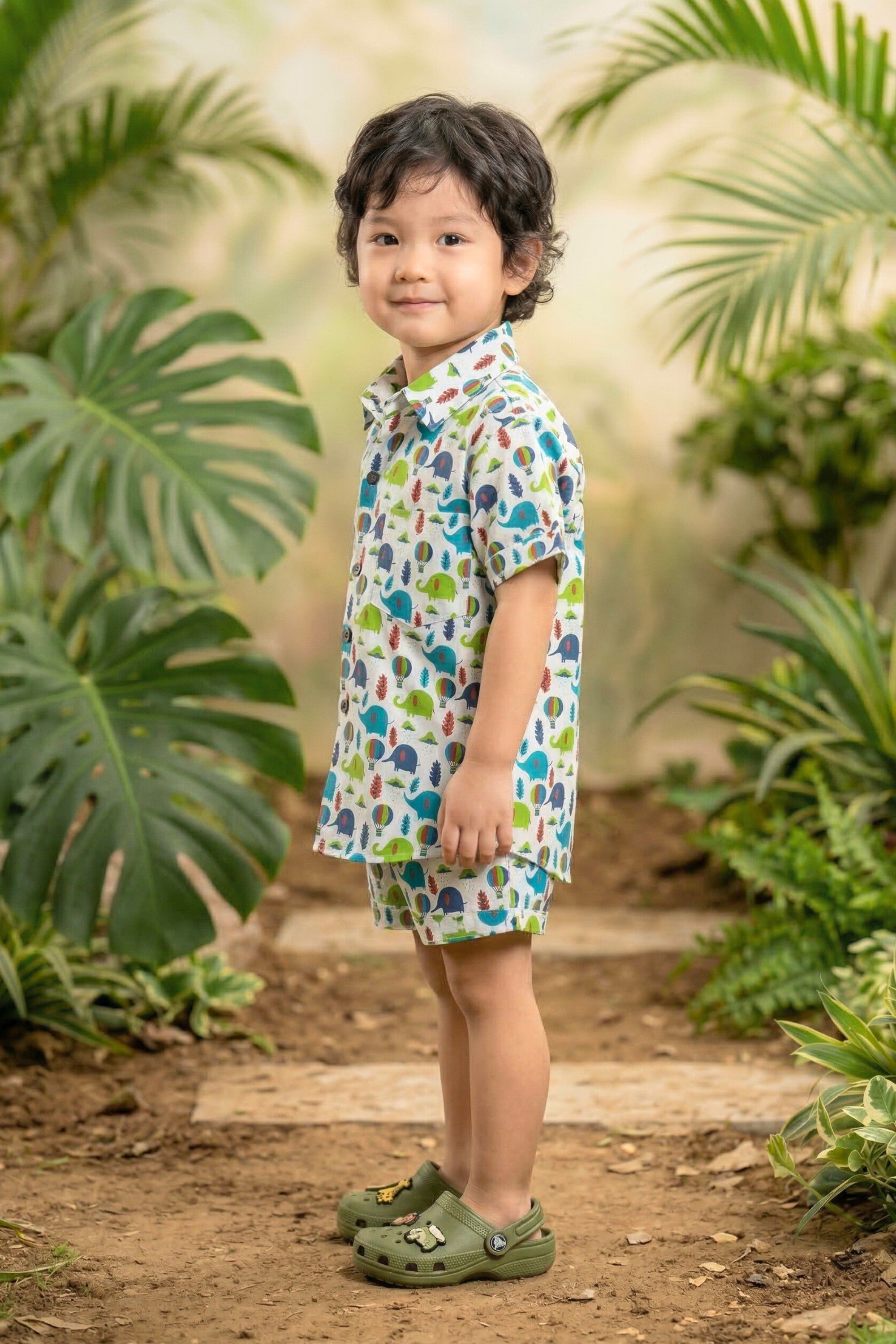 Close-up of elephant hot air balloon jungle print on white cotton fabric — boys safari coord set