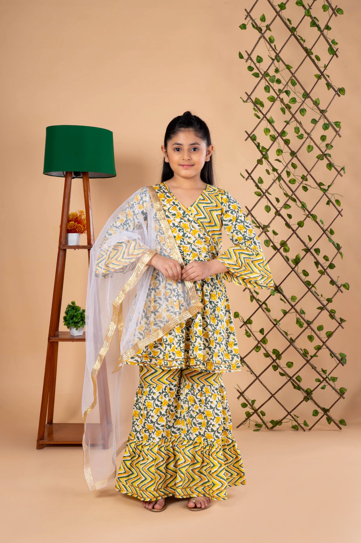 Diwali ethnic wear for girls in yellow floral sibling set (Rakhi) with kurta, palazzo, and net dupatta, perfect for festive celebrations.