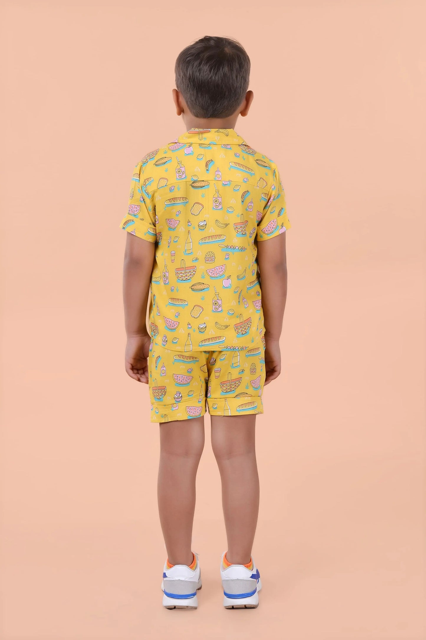 Lifestyle pose – boys yellow shirt & shorts set for holidays and playdates