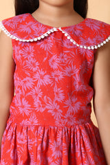 Hem detail – pom‑pom lace edging on girls red fit & flare dress