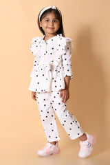 Close‑up – statement bow and ruffle peplum on girls co-ord set