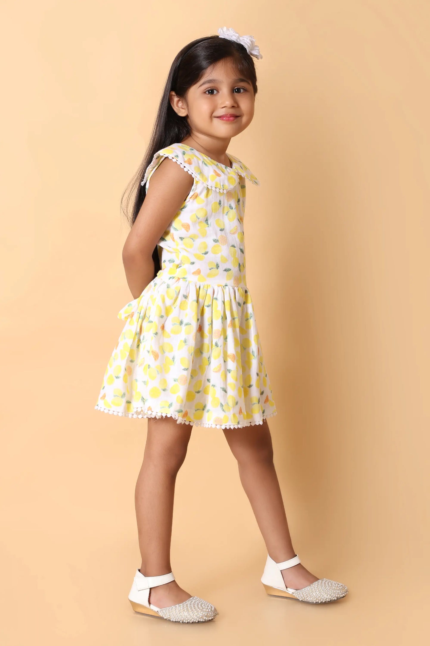 Front view – girls lemon motif dress with flared skirt, cotton feel