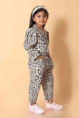 Close‑up – bold leopard pattern fabric on girls top and pant set