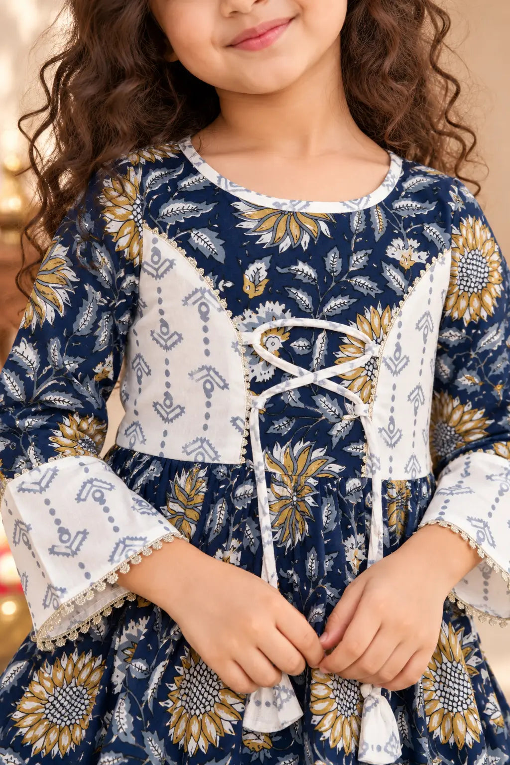 Close-up of girls navy kurti with ivory lace-up dori yoke, tassels and gold lace bell sleeves – Bebe Unicorn