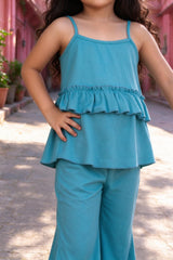 Close-up of girls teal rib-knit spaghetti strap top with chest ruffle