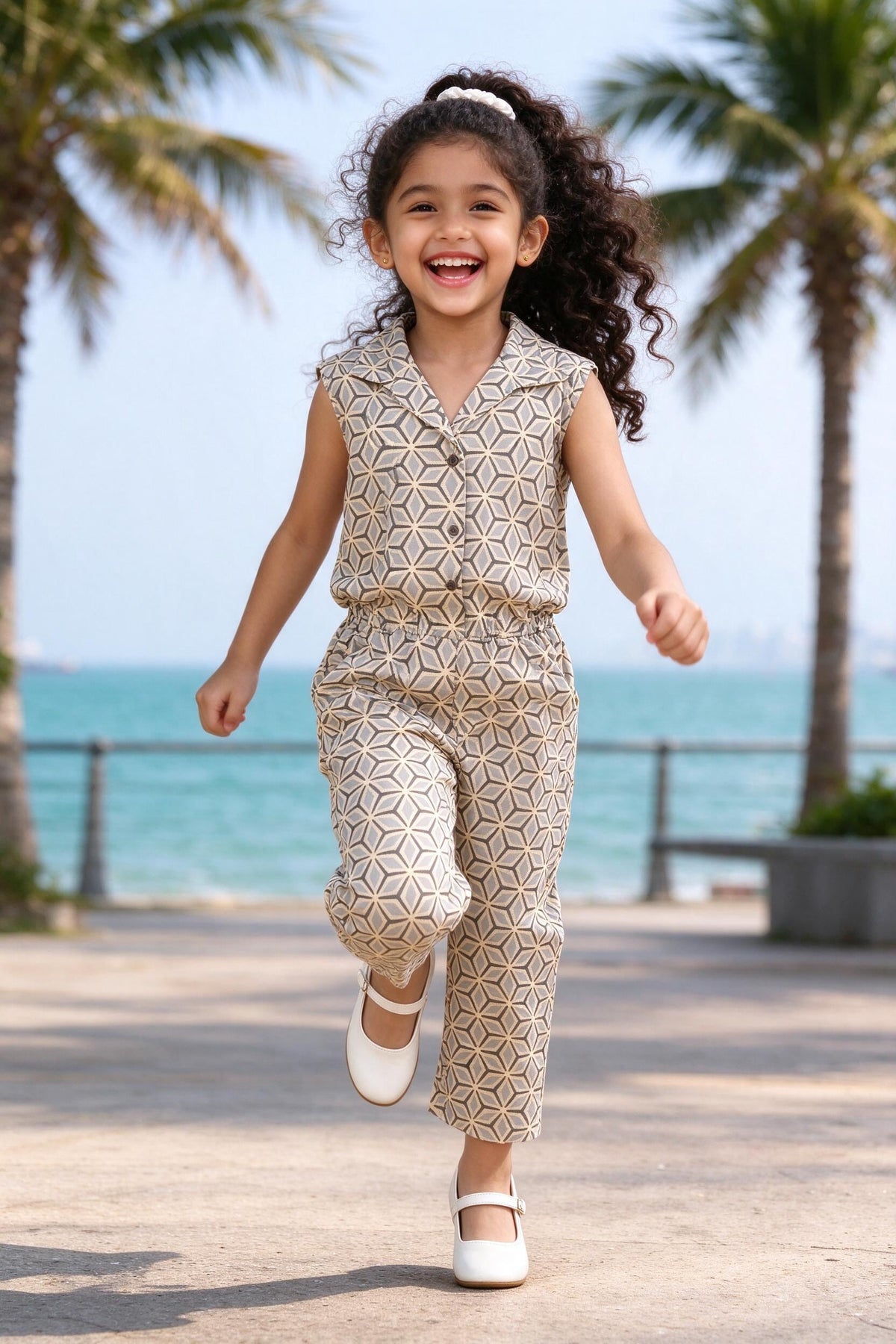 Girl wearing Girls Beige Geometric Print Cotton Jumpsuit, front view