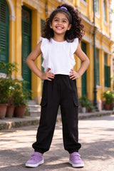 Girl wearing girls white flutter-sleeve crop top & black cargo jogger pants set, front view