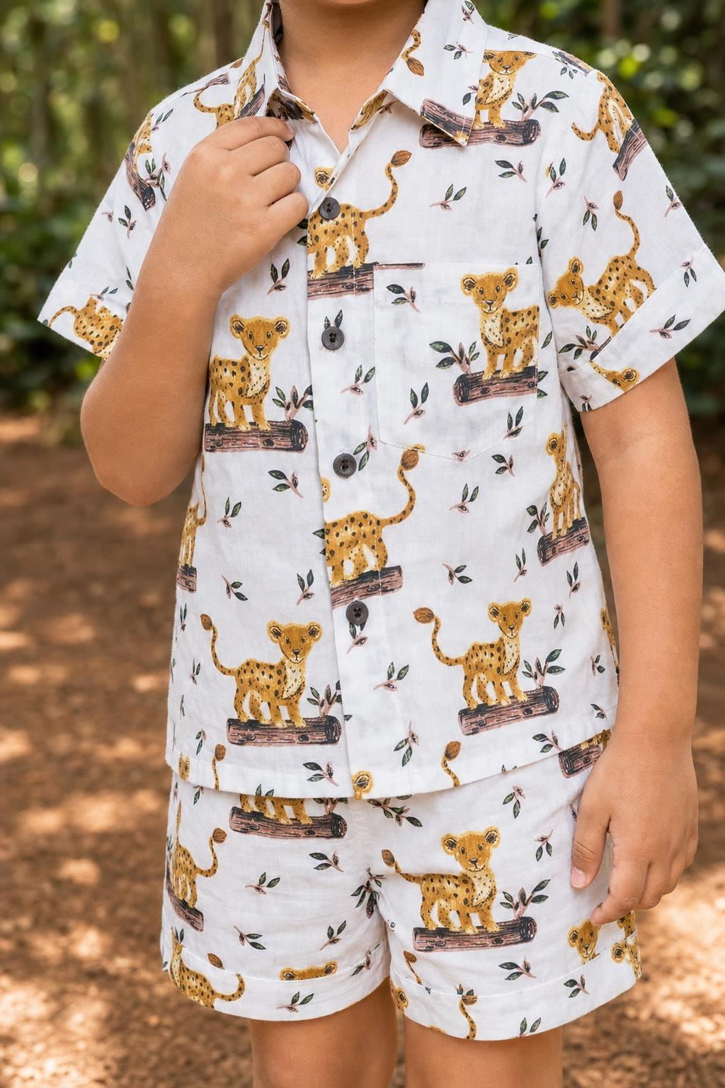 Close-up of boys leopard cub print coord set shirt print, collar and buttons
