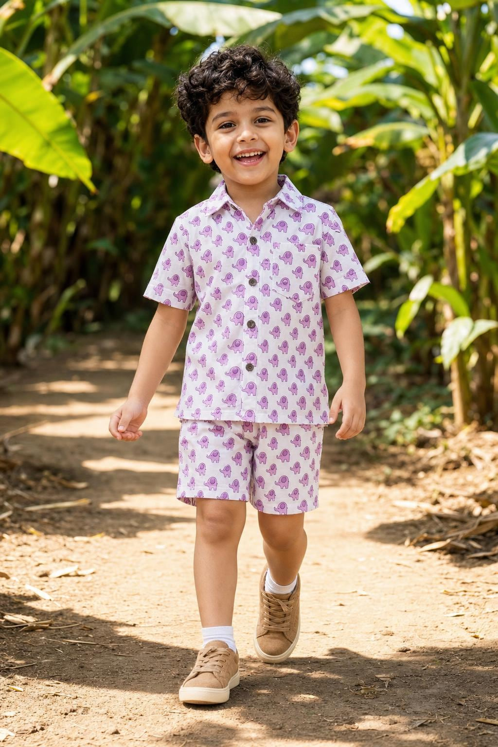 Boy wearing boys purple printed cotton coord set with matching shorts, front view