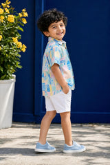 Side view of boys multicolor print linen shirt styled with white shorts