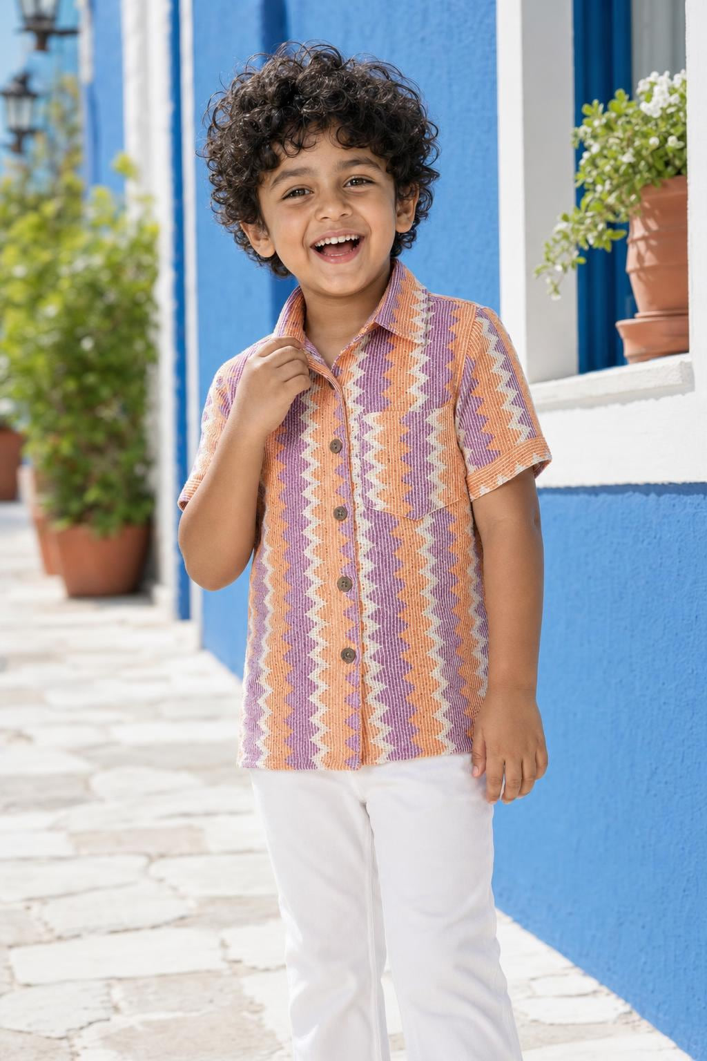 Close-up of boys orange and purple zig-zag shirt with collar and buttons