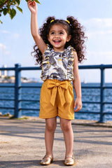 Girl wearing girls floral frilled top & mustard yellow bow shorts set, front view