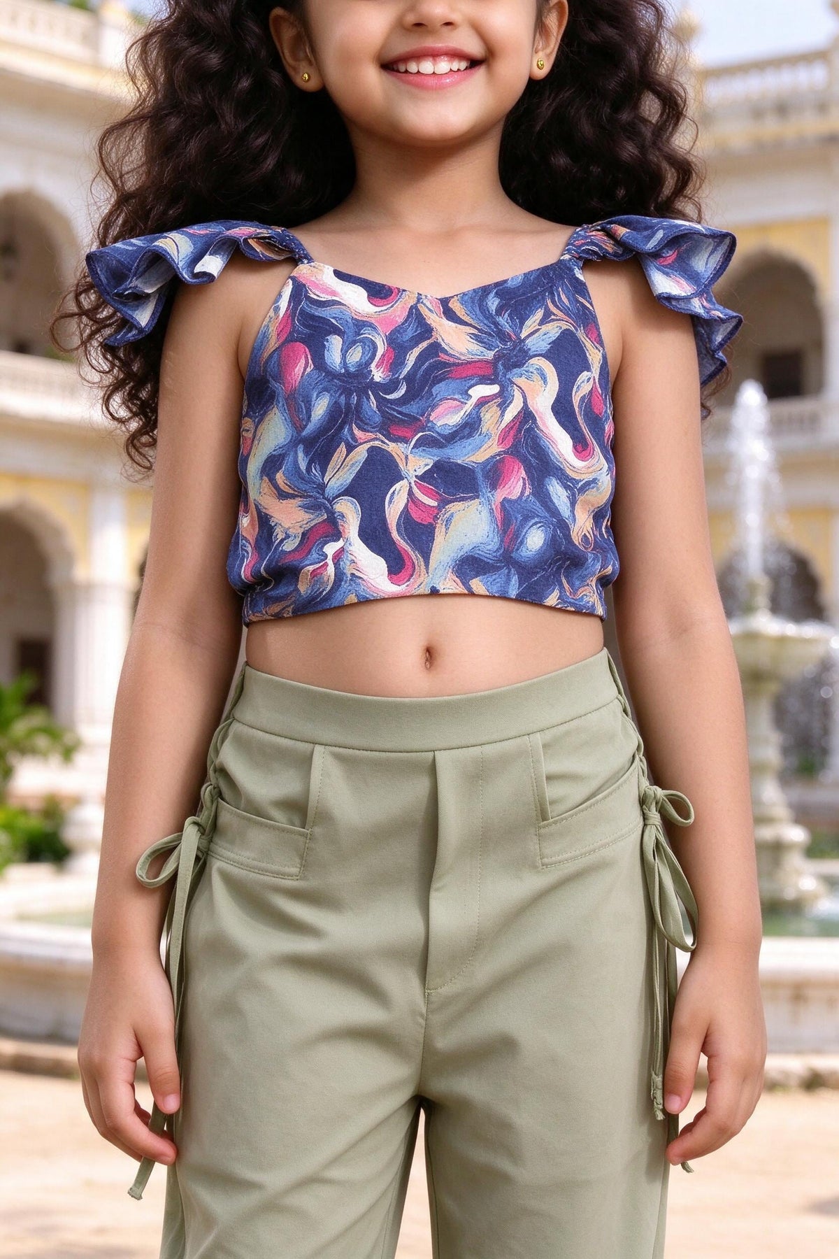 Close-up of girls flutter-frill crop top and pista trousers with side ties