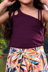 Close-up of girls wine double-strap rib top and geometric palazzo with bow tie