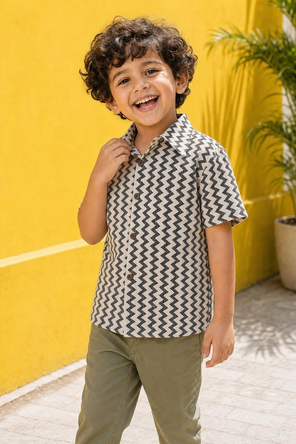 Close-up of boys black and cream zig-zag print shirt with collar and buttons